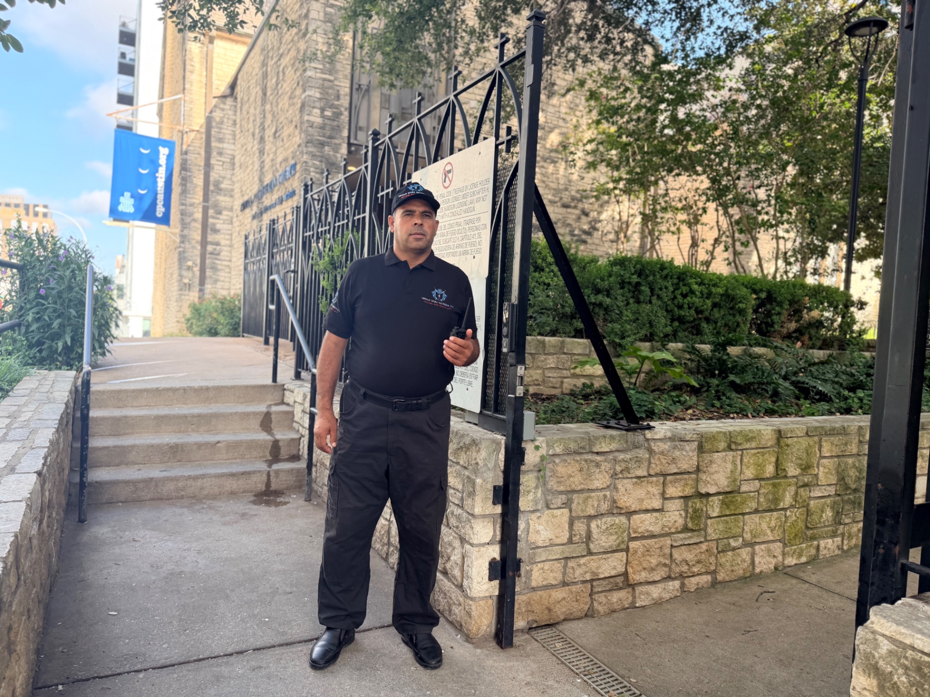 Uniformed Shield Spire Security officer maintaining a professional security presence at the controlled entrance of a private memorial gathering in Austin, Texas.