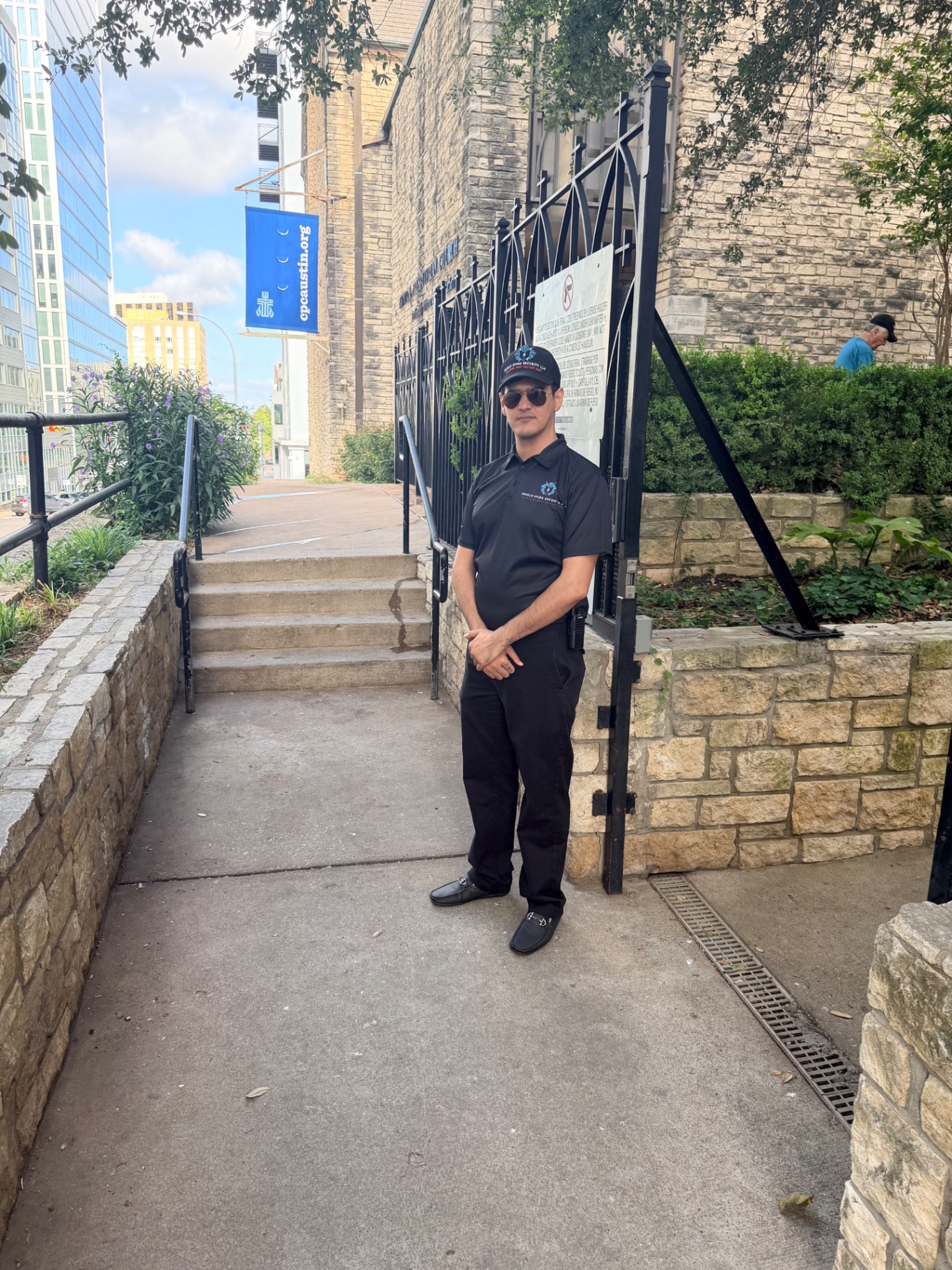 Second uniformed officer positioned at the entrance supporting invitation verification and arrival monitoring.