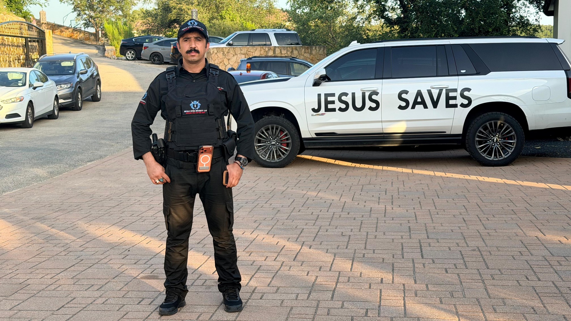 Level III Security Operations – armed officer in plate carrier providing professional deterrence near the venue.