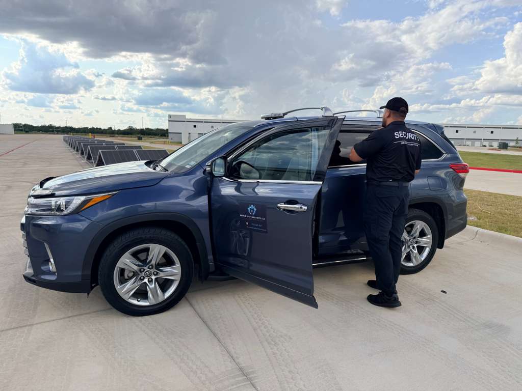 Officer preparing for an exterior patrol loop of the protected asset areas during scheduled coverage.