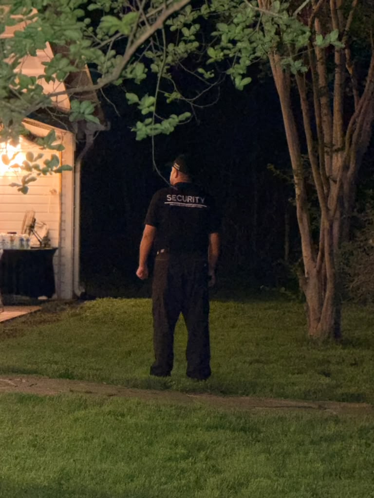 Evening coverage in progress: officer maintaining a visible presence during nighttime event operations.