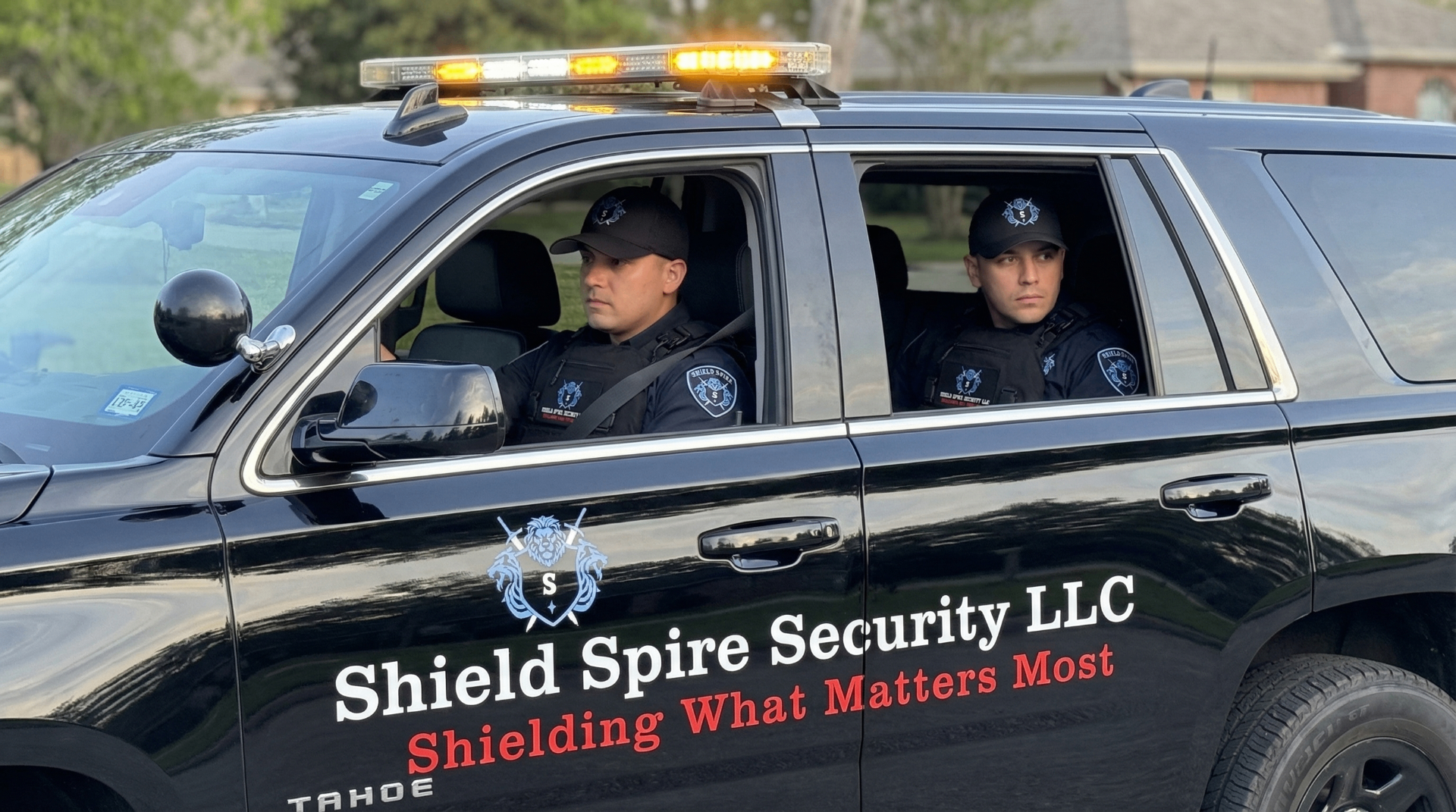 Daytime view of Shield Spire Security LLC officers in a marked patrol vehicle prepared for client escort and travel assistance.