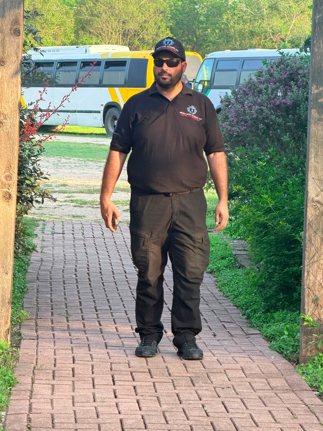 Officer conducting patrol operations along the venue pathway during event coverage.