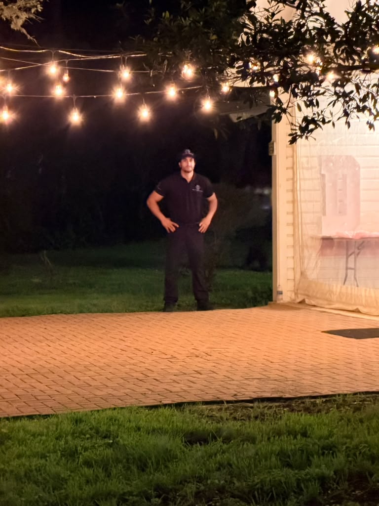 Evening venue monitoring, officer maintaining perimeter coverage during nighttime event operations.