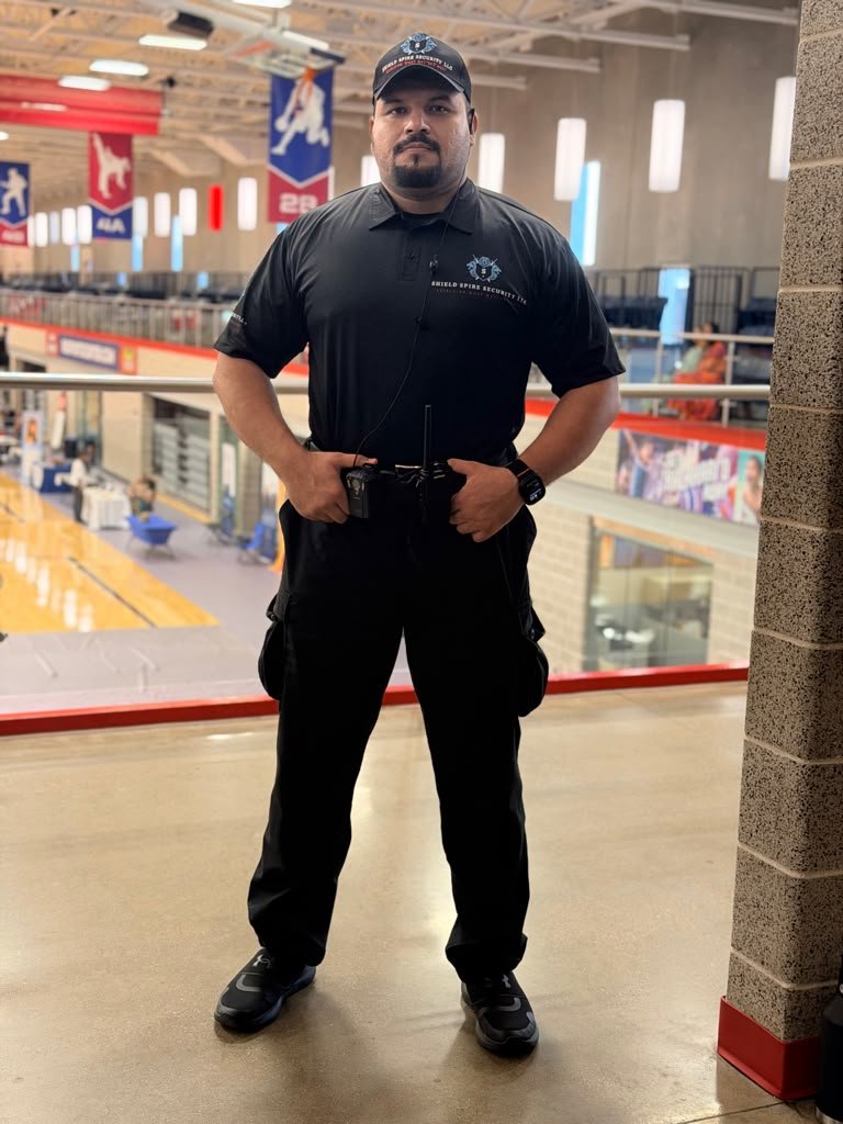 Uniformed Shield Spire Security officer maintaining a visible presence inside the event facility.
