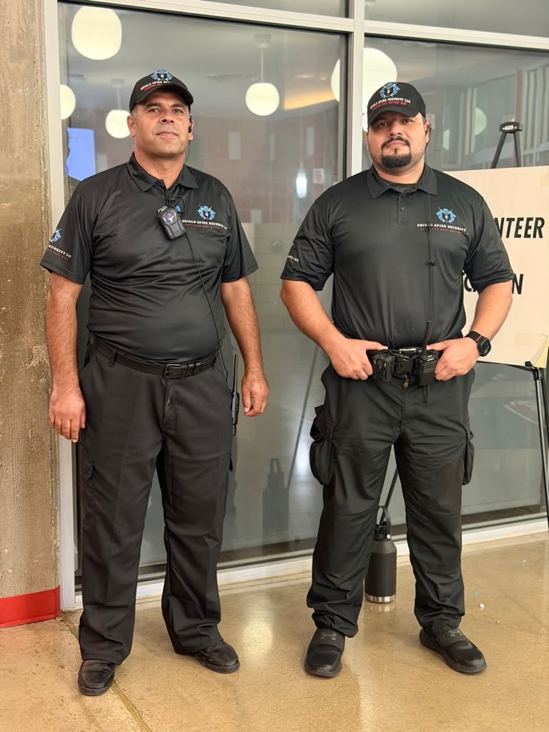 Two Shield Spire Security personnel positioned near an assigned event access and check-in area.